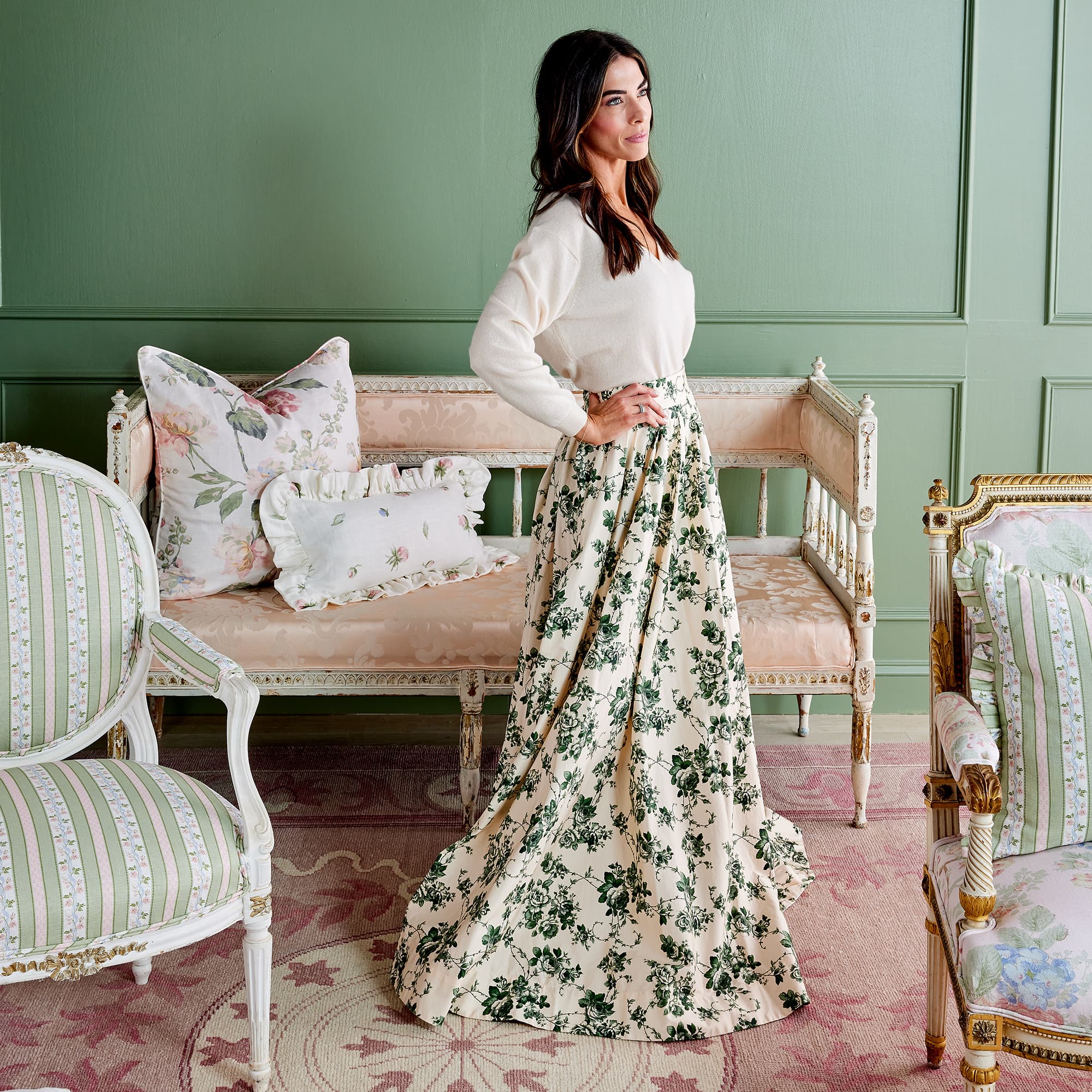 Caitlin Wilson standing in front of vintage furniture finished with Collected Fabrics and Pillows