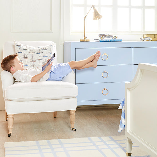 Boy Reading in Chair with Sailing Pillow