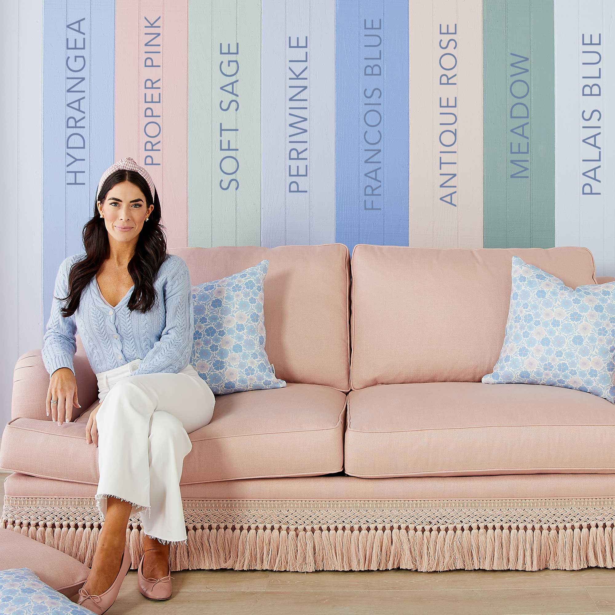 Caitlin Wilson on Sofa with Paint Color Swatches on Wall