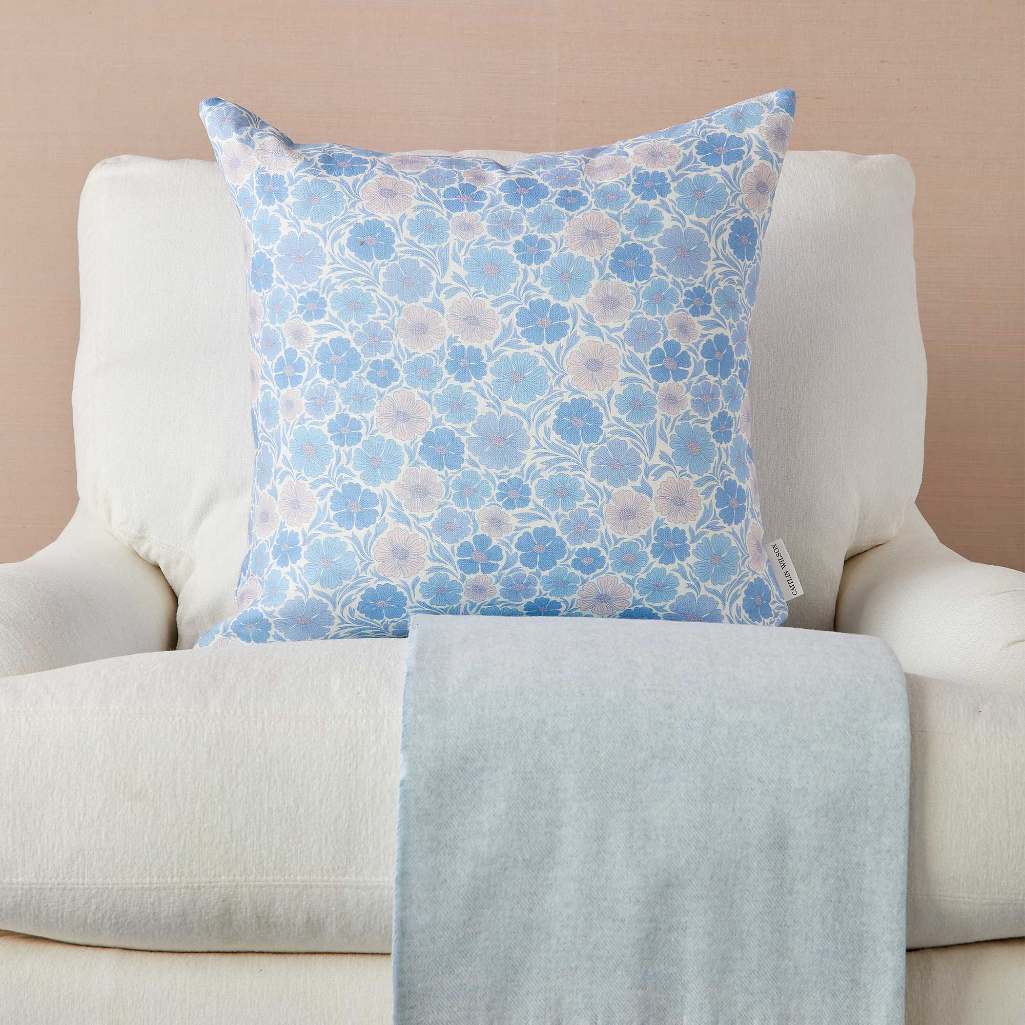 Lillian Pillow with pastel blue and pink flowers on Chair