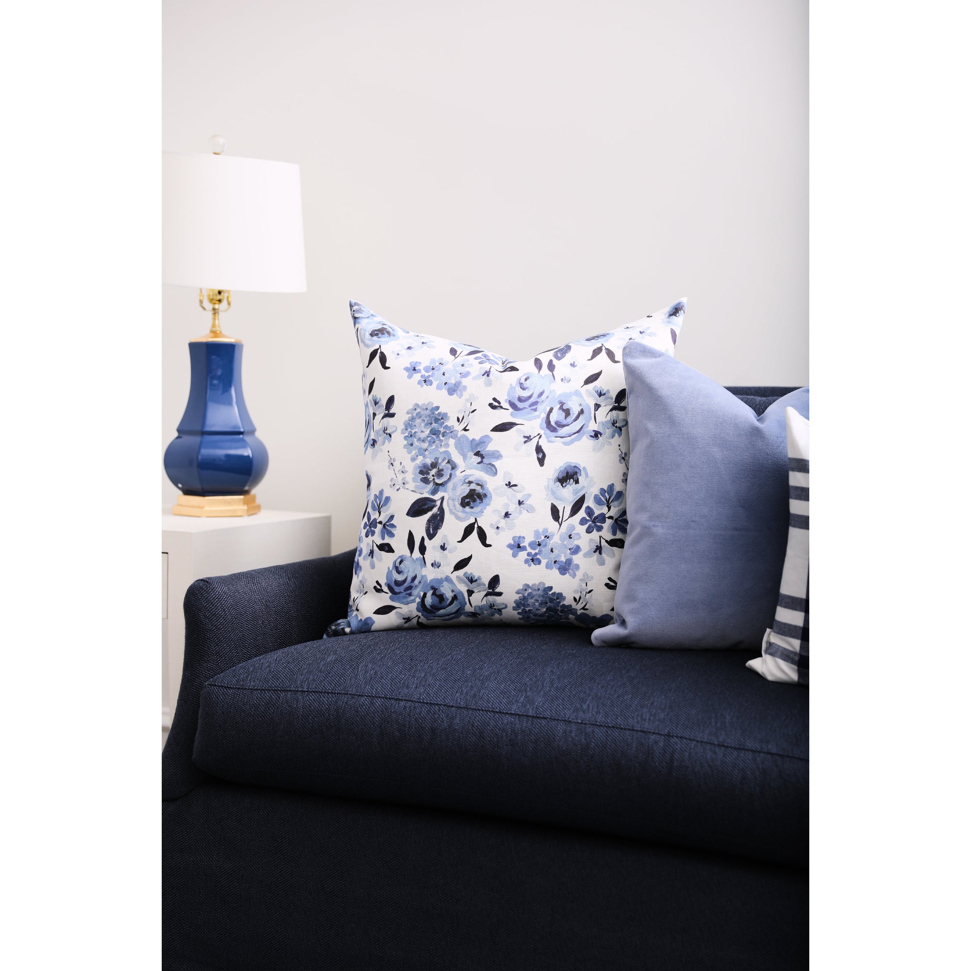 Blue Highland Floral Pillow on Navy Sofa